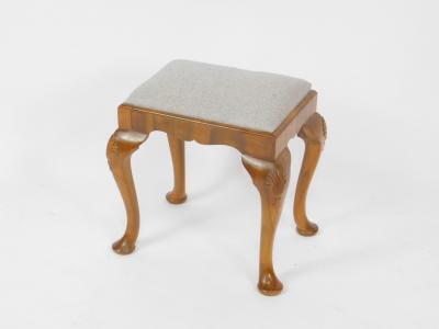 A Georgian style walnut dressing table stool