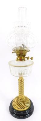 A brass spiral fluted oil lamp