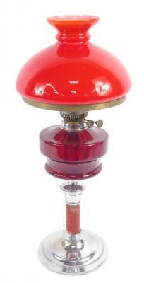 A chrome and red painted oil lamp