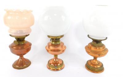 A near pair of copper and brass oil lamps