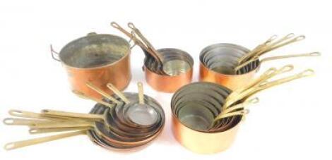 Three sets of copper saucepans