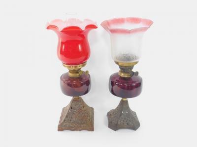 Two duplex cast iron oil lamps