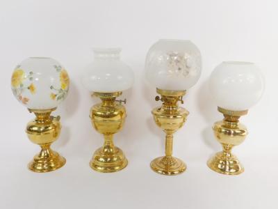 Four brass oil lamps