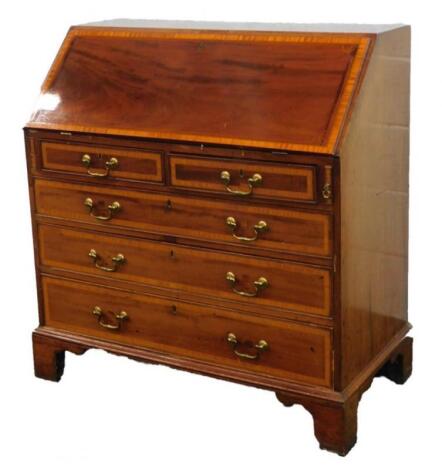 A George III mahogany and satinwood cross banded bureau