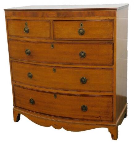 An early 19thC oak and mahogany cross banded bow fronted chest of drawers