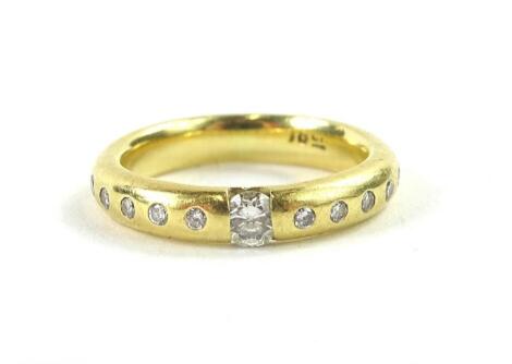 An 18ct gold diamond set wedding band