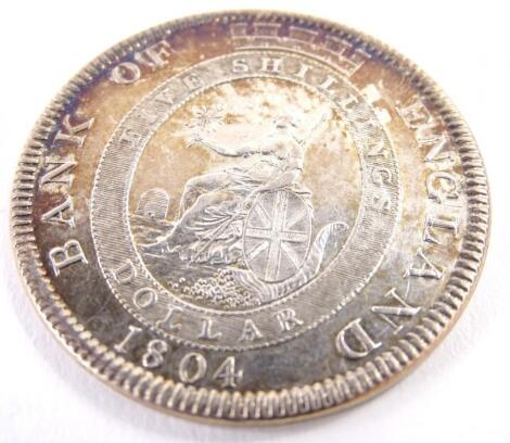 An 1804 Bank of England five shillings silver dollar.