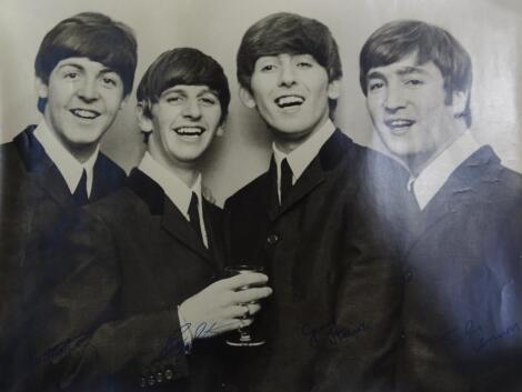 A black and white photograph of the Beatles