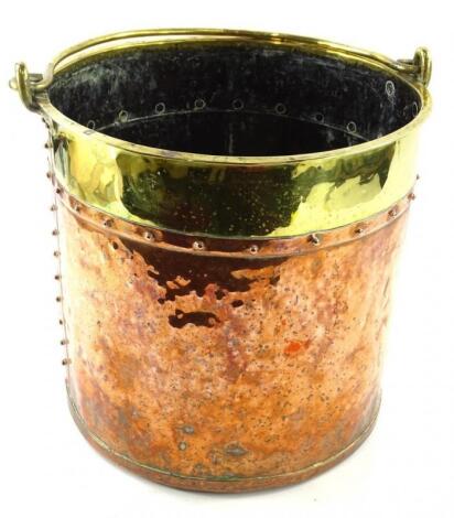 A copper and brass riveted coal bucket