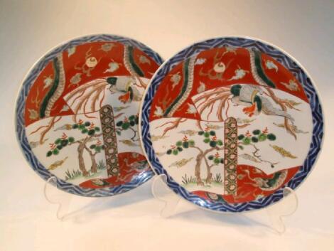 A pair of Imari chargers decorated with reserves of flowering branch decoration