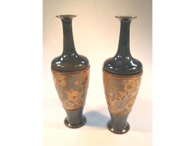 A pair of Doulton Slaters stoneware vases with slender everted necks and