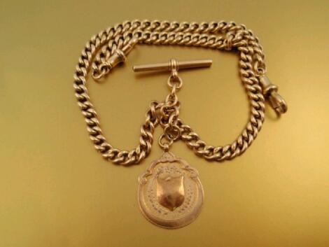 A curb link watch chain stamped 9ct with attached 9ct gold fob