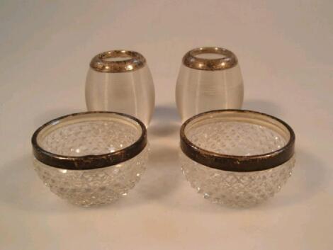 A pair of early 20thC cut glass salts with silver mounts