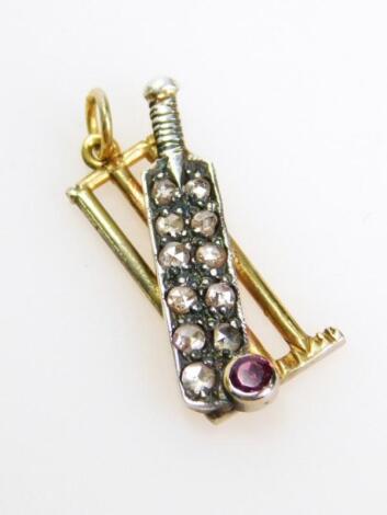 A 9ct gold and diamond cricket stumps and bat pendant