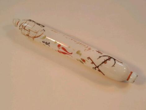 A Victorian opaque white glass rolling pin with painted decoration