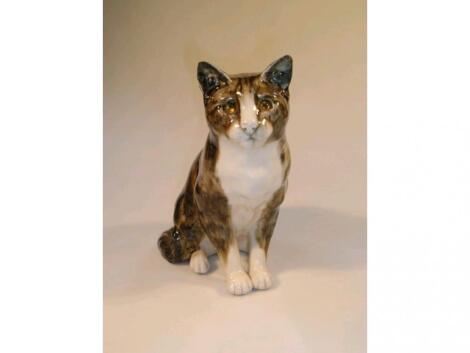 A pottery model of a seated tabby cat by Mike Hinton