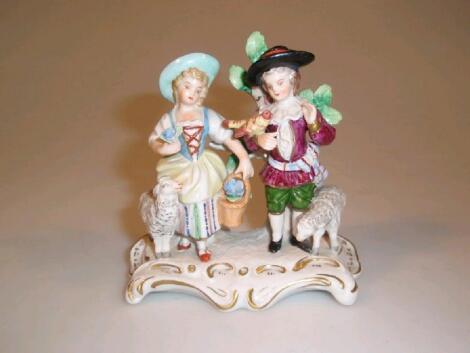 A Sitzendorf porcelain figure group of a shepherd and shepherdess