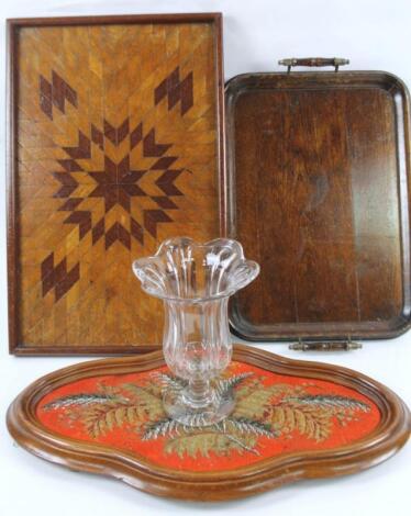 An early 20thC oak tea pot stand or tray