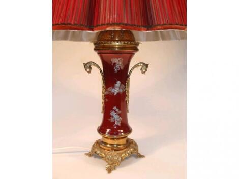 A table lamp with a magenta vase shape stem