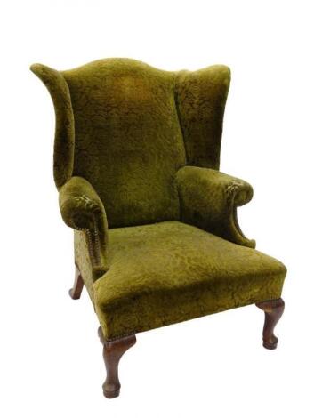 A George III style mahogany wingback armchair