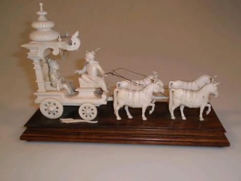 An Indian carved ivory group of a ceremonial horse drawn carriage with