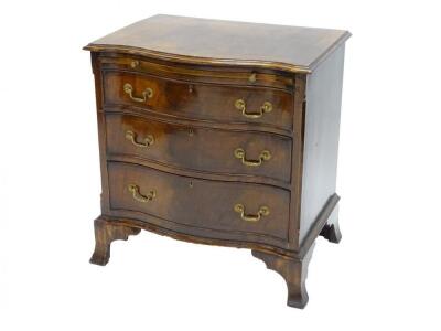 A small mahogany serpentine fronted chest of drawers