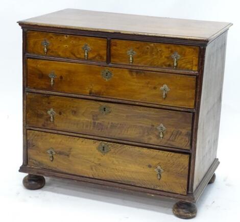 A walnut and mahogany chest of drawers