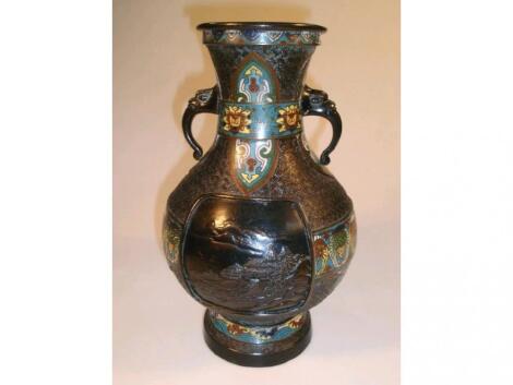 A Chinese bronze two-handled vase with reserves of landscape decoration