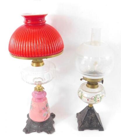 A Continental late 19thC pink glass and cast iron oil lamp