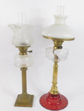 A brass and ruby glass oil lamp