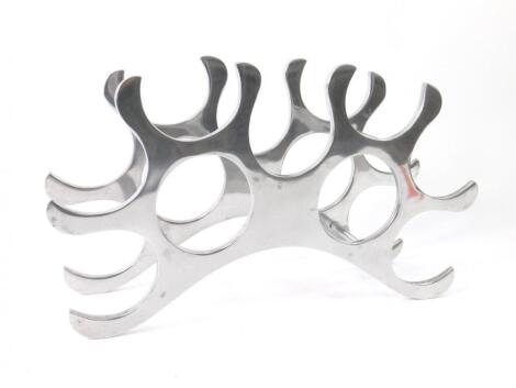 An aluminium wine rack of abstract bridge form