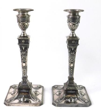 A pair of Edwardian Neo classical style silver plated candle sticks