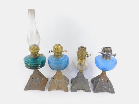 Four oil lamps with cast iron bases