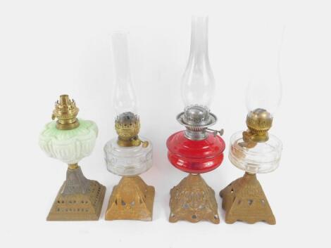 Four Victorian gilt painted cast iron oil lamps