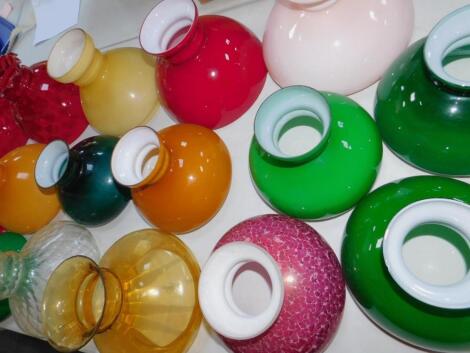 Sixteen coloured glass oil lamp shades