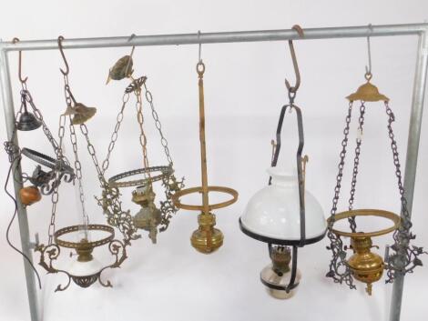 Six brass and cast iron hanging oil lamps