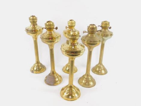 A set of six brass oil lamps