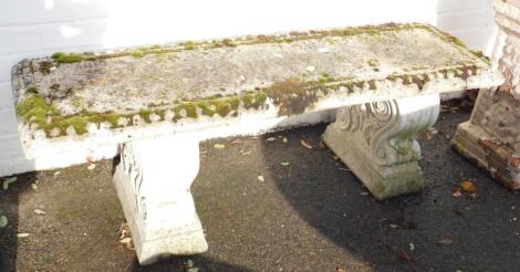 A concrete garden bench