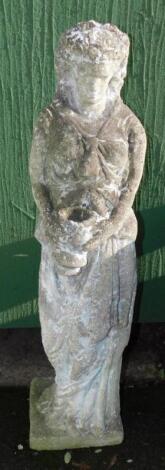 A concrete garden statue modelled as a classical woman holding a vase