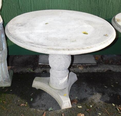 A faux marble circular garden table