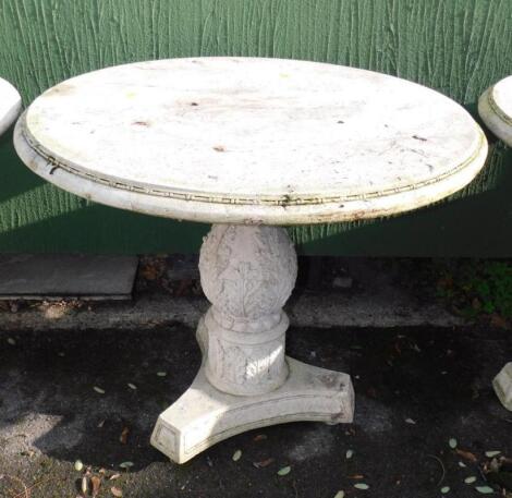 A faux marble circular garden table