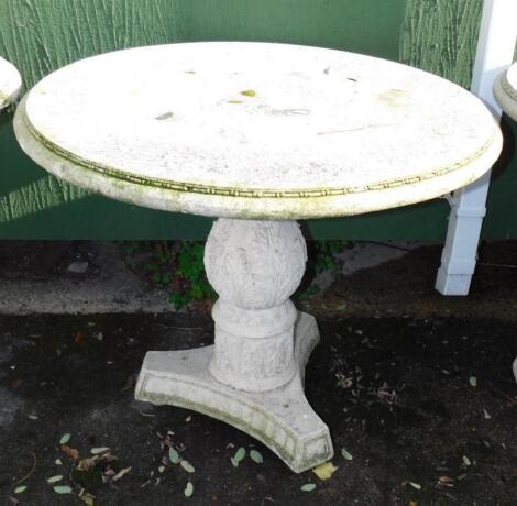 A faux marble circular garden table