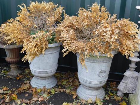 A pair of faux marble garden urns