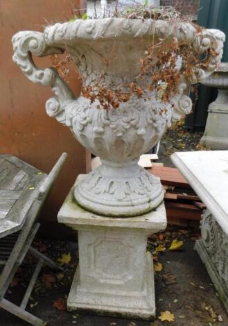 A faux marble twin handled urn on stand