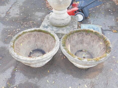 A pair of circular limestone planters