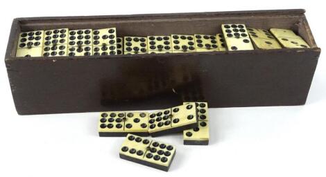 A set of bone and ebony dominoes.