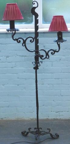 A wrought iron two branch standard lamp