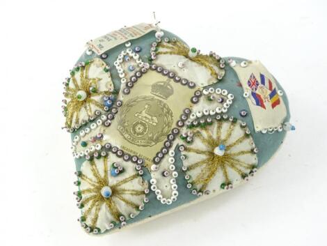 An early 20thC East Lancashire regimental heart shaped love token pin cushion