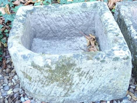 A corner hewn stone trough or sink