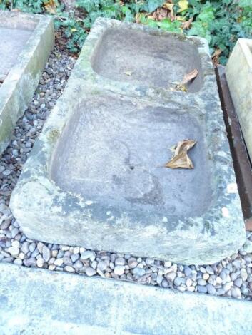 A hewn stone double sink or trough